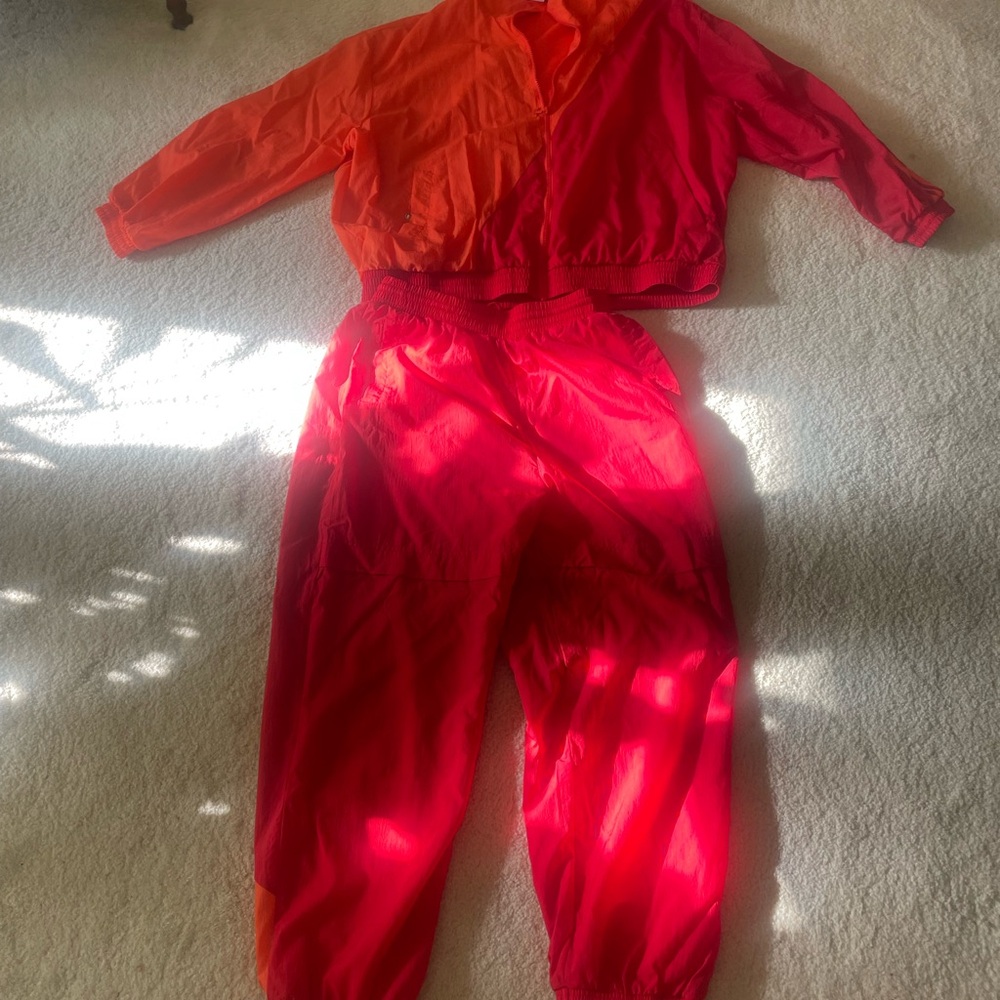 Women’s Adidas sweatsuit red and orange. This item is used.